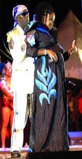 BABY TALK: Pregnant Fay-Ann Lyons-Alvarez is embraced by her father, Austin "SuperBlue" Lyons, as she holds the microphone to her belly while a recording of a chanting baby is played during her performance of "Meet SuperBlue" in the bmobile Soca Monarch Finals. babytalk