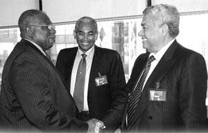FINANCIAL HEAVYWEIGHTS: Governor of the Central Bank, Ewart Williams, left and CL Financial Chairman, Lawrence Duprey and Andre Monteil greet each other before a press conference at the Central Bank on January 30. - Photo: CURTIS CHASE gcbew