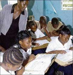 Kisha Goulbourne, a Grade Six Achievement Test teacher at St Aloysius Primary School in Kingston, gave extra lesson to students yesterday, as they prepare for next week's exams. - Norman Grindley/Chief Photographer kishagoulbourne