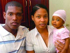 time running out: Baby Kyra Dennis with her parents Krystal Downer and Brendon Dennis, during a recent interview at Express House, Independence Square, Port of Spain. livertransplant