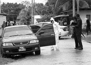looking for clues: Investigators gather evidence at Train Line Road, Pinto Road, Arima, where three men were fatally shot yesterday. The killings were among five which took the murder toll to 54. lookingforclues