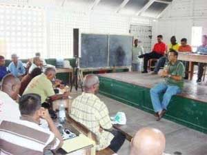 Robert Persaud (sitting on stage) addressing the farmers. (GINA photo) robertpersaud