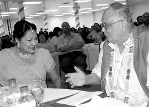 HAVING DINNER: Siparia MP Kamla Persad-Bissessar, left, chats with Maha Sabha secretary general, Sat Maharaj during the Sanatan Dharma Maha Sabha's Indian Arrival Day Dinner at the Centre of Excellence, Macoya, on Friday night. sipariampkamlapersadbissess