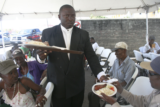 pastor_desmond_herbert_assisting_with_the_distribution_of_meals_during_the_launch_of_his_foundation