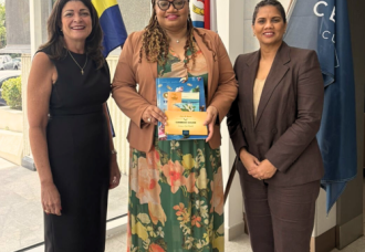 Minister of Finance, Marinka J. Gumbs, Presented with Historical NAf Book and Caribbean Guilder Collector’s Set.